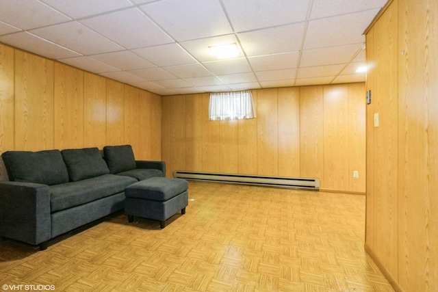 613 E 3rd St Unit 4, Lockport, IL 60441 - living room featuring baseboard heating, wooden walls, and a drop ceiling