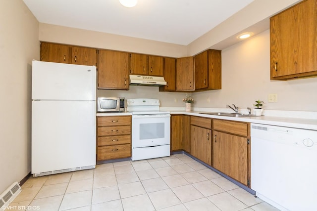 613 E 3rd St Unit 4, Lockport, IL 60441 - kitchen featuring white appliances, under cabinet range hood, brown cabinetry, and light countertops
