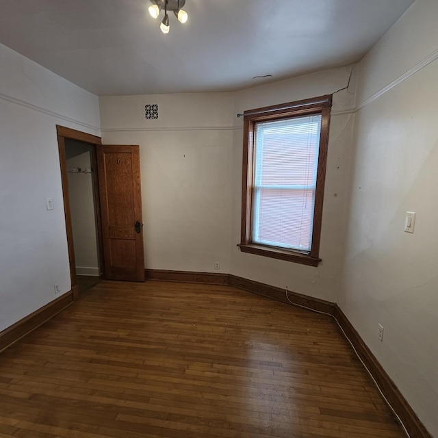 3054 N Kedzie Ave Unit 1F, Chicago, IL 60618 - empty room featuring dark wood-style flooring and baseboards