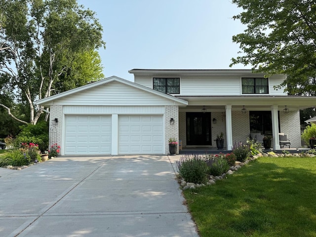 1303 Jane Ave, Naperville, IL 60540 - view of front of property with an attached garage, concrete driveway, brick siding, and a porch