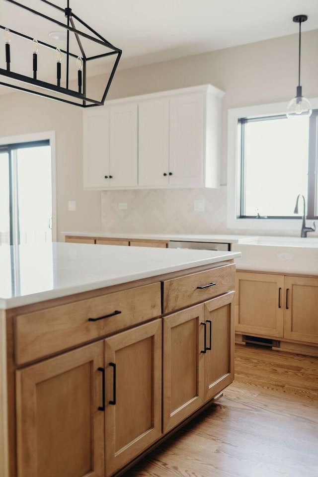 20277 Brendan St, Frankfort, IL 60423 - kitchen featuring decorative light fixtures, light wood finished floors, light countertops, and a sink