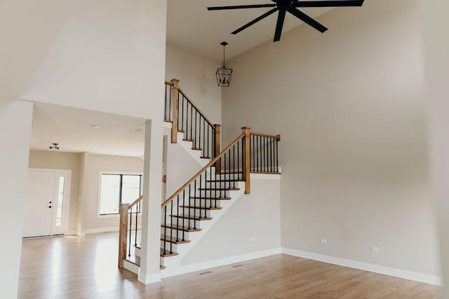20277 Brendan St, Frankfort, IL 60423 - staircase with high vaulted ceiling, a ceiling fan, wood finished floors, and baseboards