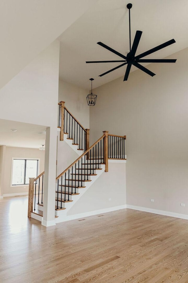20277 Brendan St, Frankfort, IL 60423 - stairway with high vaulted ceiling, wood finished floors, a ceiling fan, and baseboards