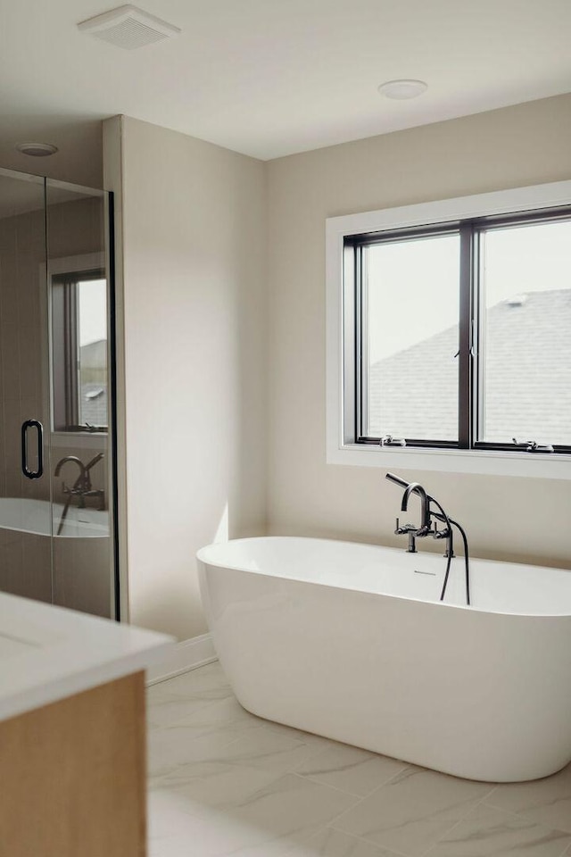 20277 Brendan St, Frankfort, IL 60423 - full bathroom featuring marble finish flooring, vanity, a freestanding tub, and a stall shower