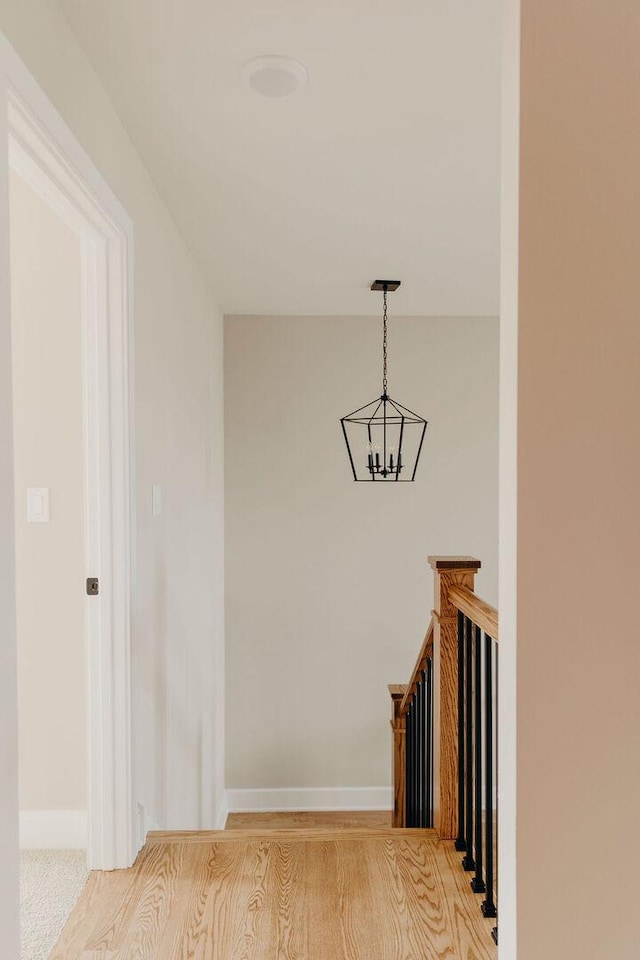 20277 Brendan St, Frankfort, IL 60423 - hallway featuring a chandelier, baseboards, and light wood-style flooring