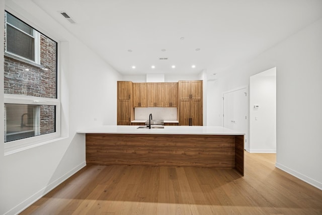 1333 E Madison Park, Chicago, IL 60615 - kitchen with brown cabinets, a peninsula, light wood finished floors, light countertops, and recessed lighting