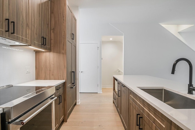 1333 E Madison Park, Chicago, IL 60615 - kitchen featuring stainless steel electric range oven, under cabinet range hood, light wood-style floors, and light countertops