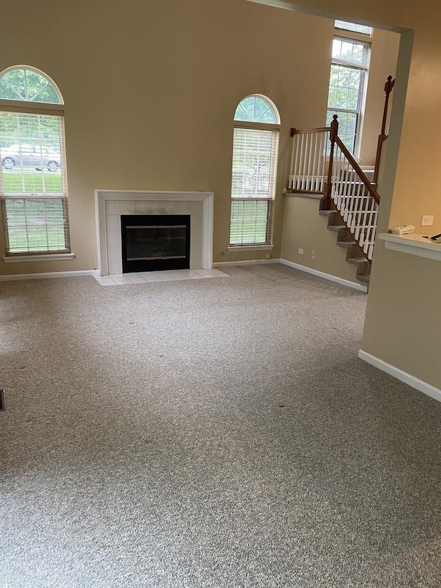 1611 Woodcrest Cir, Mundelein, IL 60060 - unfurnished living room featuring a tile fireplace, carpet flooring, and stairs