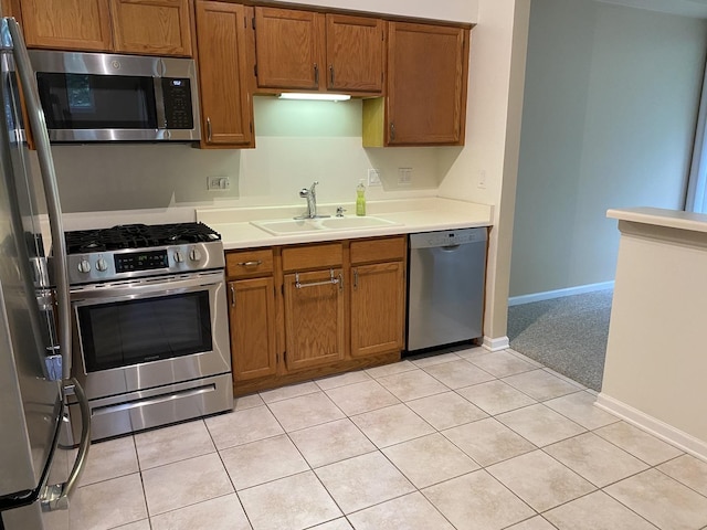 1611 Woodcrest Cir, Mundelein, IL 60060 - kitchen featuring appliances with stainless steel finishes, brown cabinetry, light countertops, and light tile patterned floors