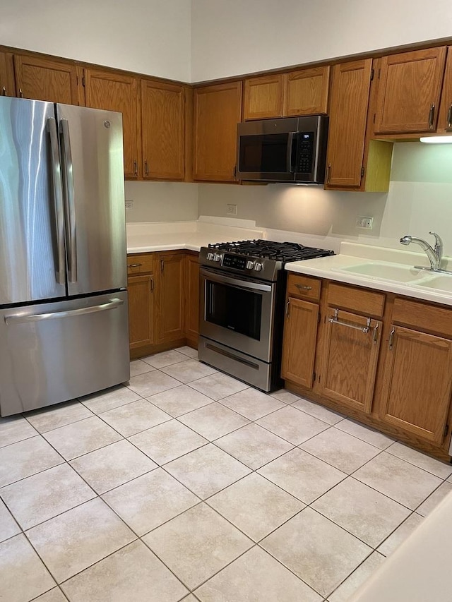 1611 Woodcrest Cir, Mundelein, IL 60060 - kitchen with stainless steel appliances, brown cabinetry, and light countertops