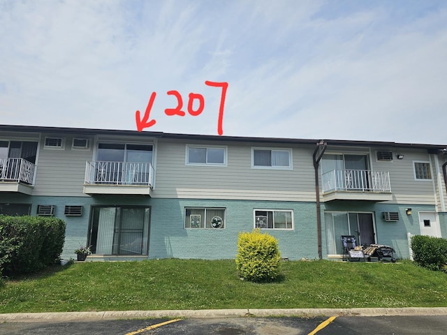 850 E Old Willow Rd Unit 207, Prospect Heights, IL 60070 - view of property with a wall mounted AC and uncovered parking