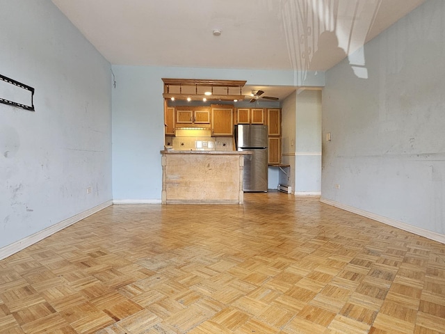 850 E Old Willow Rd Unit 207, Prospect Heights, IL 60070 - unfurnished living room with baseboards and ceiling fan