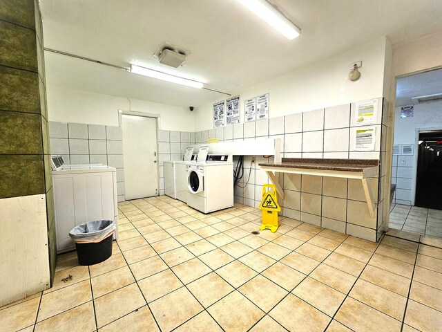 850 E Old Willow Rd Unit 207, Prospect Heights, IL 60070 - shared laundry room with washing machine and dryer, tile walls, and light tile patterned flooring