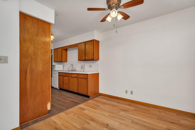 1635 N 4012th Rd, Earlville, IL 60518 - kitchen featuring white appliances, brown cabinetry, light wood-style floors, light countertops, and tasteful backsplash