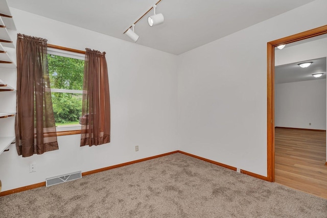 1635 N 4012th Rd, Earlville, IL 60518 - carpeted spare room featuring baseboards and rail lighting
