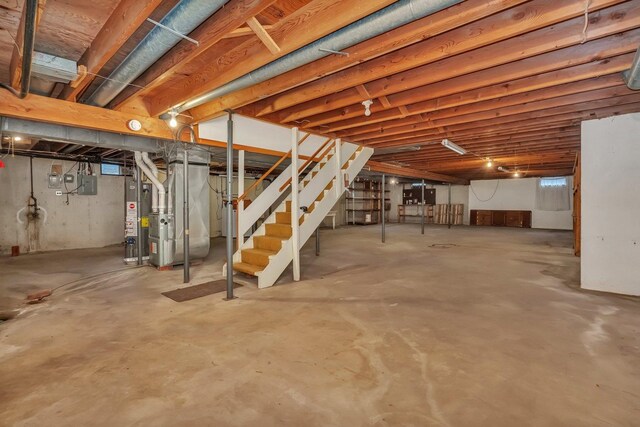1635 N 4012th Rd, Earlville, IL 60518 - unfinished below grade area featuring stairs, heating unit, electric panel, and water heater