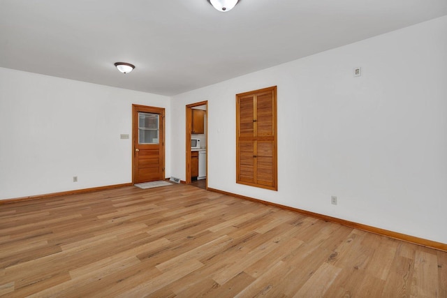 1635 N 4012th Rd, Earlville, IL 60518 - spare room with baseboards and light wood-style flooring