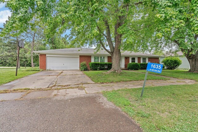 1635 N 4012th Rd, Earlville, IL 60518 - ranch-style home with brick siding, driveway, a front lawn, and an attached garage
