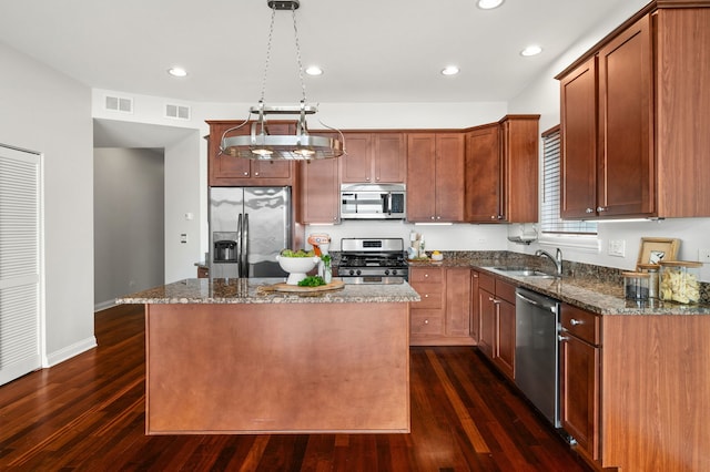 2847 N Pulaski Rd Unit 3S, Chicago, IL 60641 - kitchen with appliances with stainless steel finishes, dark wood-style flooring, dark stone countertops, a kitchen island, and recessed lighting