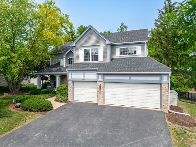 1132 Locust Ct, Bartlett, IL 60103 - traditional home with roof with shingles, an attached garage, driveway, and brick siding