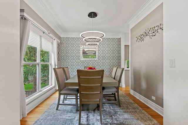 1132 Locust Ct, Bartlett, IL 60103 - dining room with wallpapered walls, an accent wall, ornamental molding, wood finished floors, and a chandelier