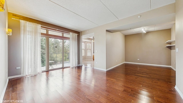 720 Prestwick Ln Unit 207, Wheeling, IL 60090 - unfurnished room with hardwood / wood-style flooring, baseboards, and a textured ceiling