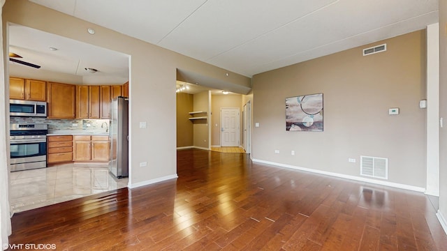 720 Prestwick Ln Unit 207, Wheeling, IL 60090 - unfurnished living room featuring light wood-style floors and baseboards