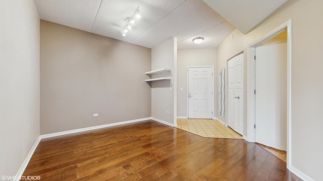 720 Prestwick Ln Unit 207, Wheeling, IL 60090 - spare room with wood-type flooring, baseboards, and a textured ceiling