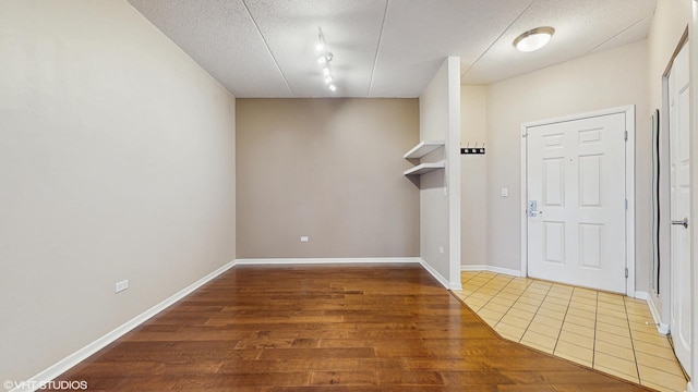 720 Prestwick Ln Unit 207, Wheeling, IL 60090 - foyer entrance featuring a textured ceiling, wood finished floors, and baseboards