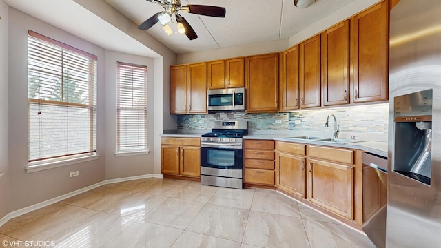 720 Prestwick Ln Unit 207, Wheeling, IL 60090 - kitchen with appliances with stainless steel finishes, a sink, light countertops, backsplash, and a ceiling fan