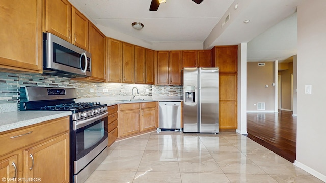 720 Prestwick Ln Unit 207, Wheeling, IL 60090 - kitchen with appliances with stainless steel finishes, a sink, light countertops, backsplash, and ceiling fan