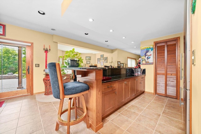 25014 W Nicklaus Way, Antioch, IL 60002 - kitchen featuring a breakfast bar, light tile patterned floors, a peninsula, dark countertops, and recessed lighting