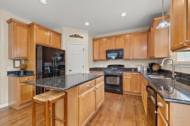 11582 Beacon Ave, Huntley, IL 60142 - kitchen with black appliances, light wood-style flooring, a center island, a kitchen bar, and recessed lighting