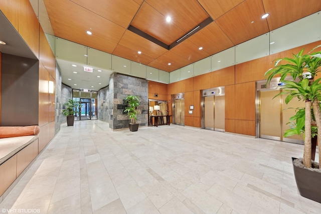 208 W Washington St Unit 1205, Chicago, IL 60606 - building lobby featuring a towering ceiling, wooden ceiling, recessed lighting, and wood walls