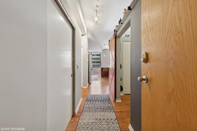 208 W Washington St Unit 1205, Chicago, IL 60606 - hallway featuring a barn door and light wood-type flooring