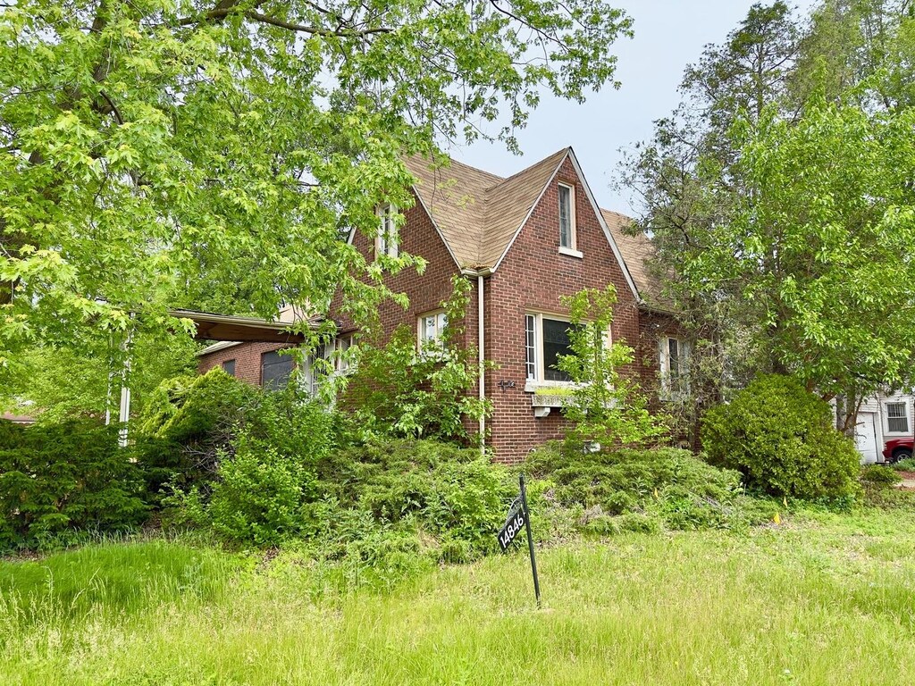14846 Woodlawn Ave, Dolton, IL 60419 - view of front facade featuring brick siding and roof with shingles