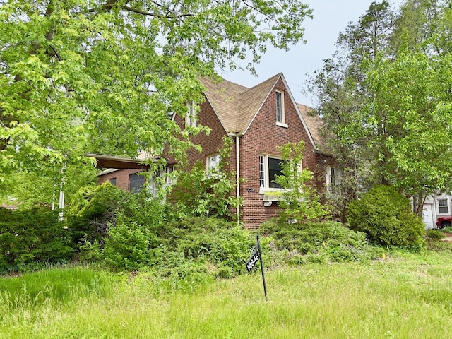 14846 Woodlawn Ave, Dolton, IL 60419 - view of front facade featuring brick siding and roof with shingles