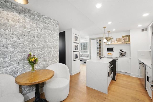 88 W Schiller St Unit 1001L, Chicago, IL 60610 - kitchen with light countertops, light wood-style flooring, white cabinetry, dishwasher, and recessed lighting