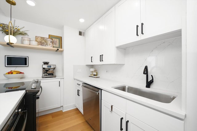 88 W Schiller St Unit 1001L, Chicago, IL 60610 - kitchen with stainless steel dishwasher, electric stove, light wood finished floors, backsplash, and white cabinetry