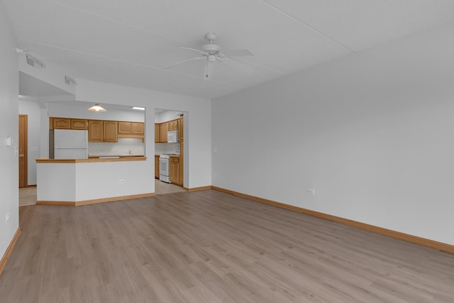 5055 W Madison St Unit 511, Skokie, IL 60077 - unfurnished living room with ceiling fan and light wood-style floors