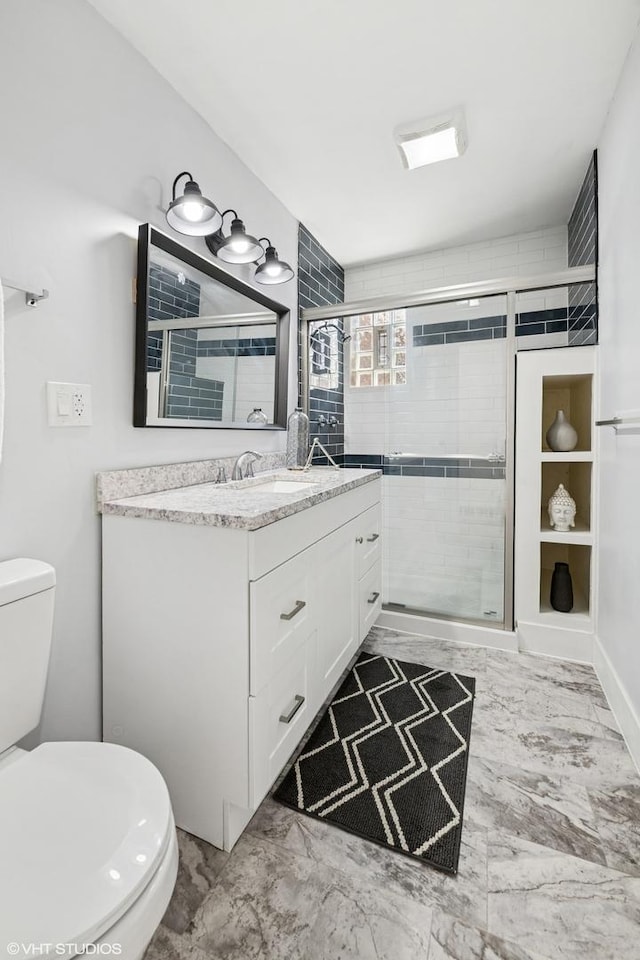 5247 N California Ave, Chicago, IL 60625 - bathroom with vanity, a stall shower, and marble finish flooring