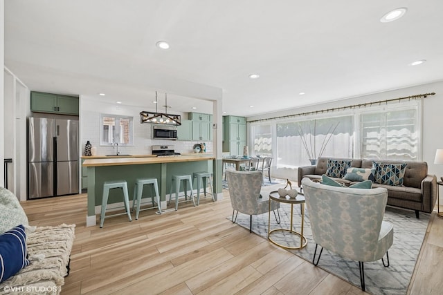 5247 N California Ave, Chicago, IL 60625 - living area featuring light wood-style flooring, a chandelier, and recessed lighting