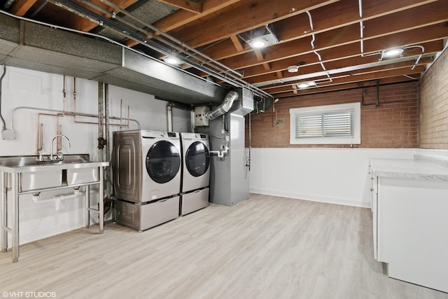 316 Nellie Ct, Glenview, IL 60025 - laundry room with washing machine and dryer, light wood finished floors, brick wall, and heating unit