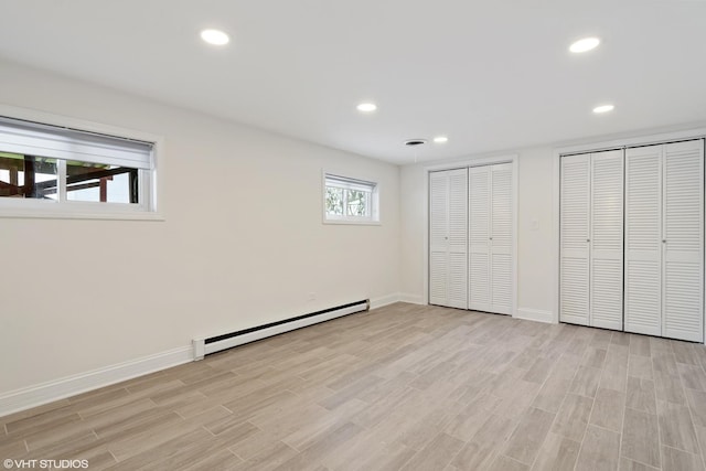316 Nellie Ct, Glenview, IL 60025 - unfurnished bedroom featuring baseboard heating, two closets, recessed lighting, and light wood-style floors