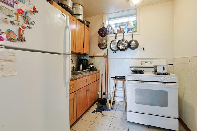 392 Plum Ct, Elgin, IL 60120 - kitchen featuring white appliances, light tile patterned floors, and brown cabinetry