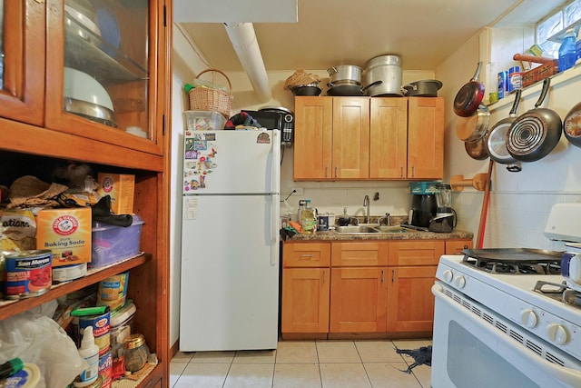 392 Plum Ct, Elgin, IL 60120 - kitchen featuring white appliances, light tile patterned floors, and brown cabinets