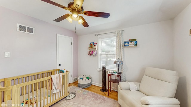 1910 N 76th Ct, Elmwood Park, IL 60707 - bedroom with a nursery area, wood finished floors, ceiling fan, and baseboards