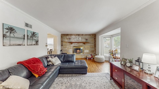 1910 N 76th Ct, Elmwood Park, IL 60707 - living room with crown molding, a fireplace, and light wood-style flooring