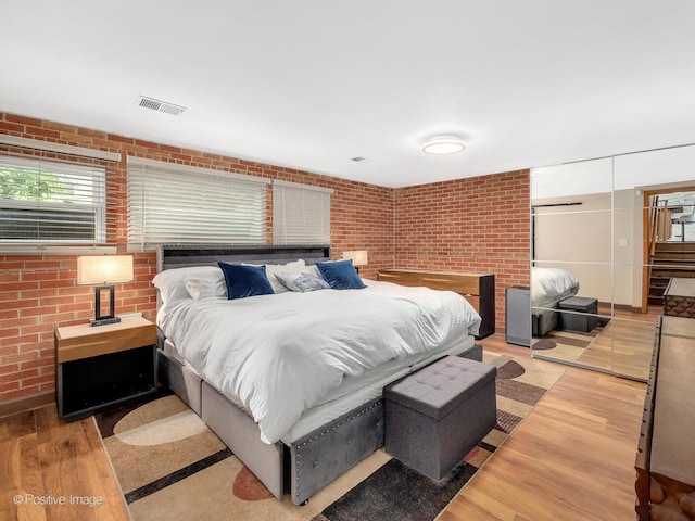400 E Garwood Ave, Mount Prospect, IL 60056 - bedroom with brick wall, light wood-style flooring, and a closet
