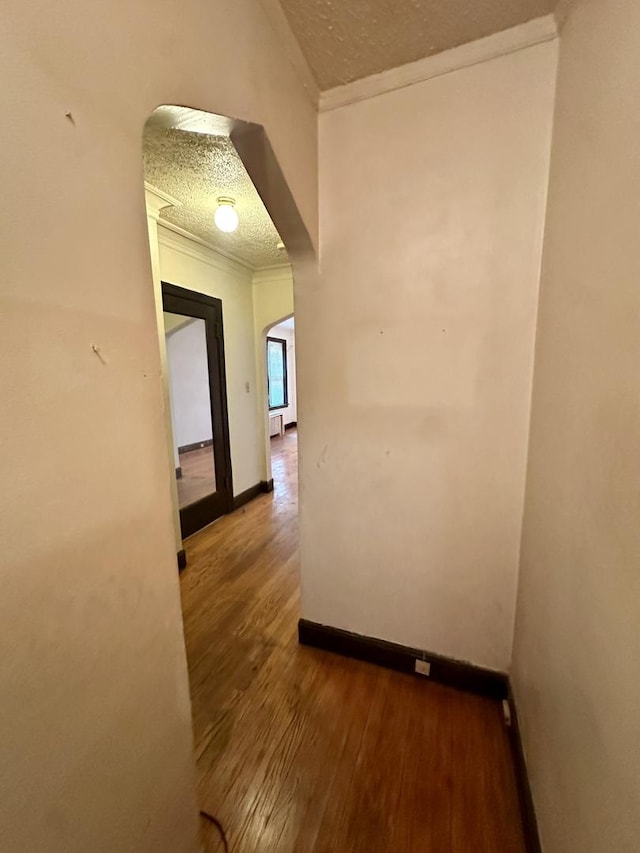 1453 W Elmdale Ave Unit 1, Chicago, IL 60660 - corridor with arched walkways, wood finished floors, crown molding, baseboards, and a textured ceiling